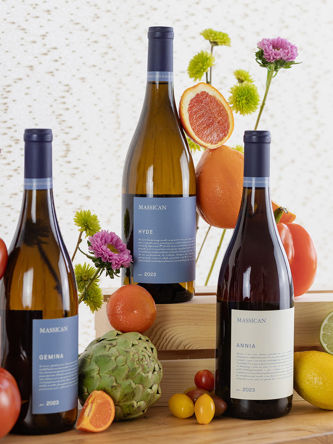Massican Wines Surrounded by a Farmer's Market Find - Fruits, vegetables, flowers. Massican Annia White Wine and Gemina White Wine and Hyde Vineyard Chardonnay pictured.